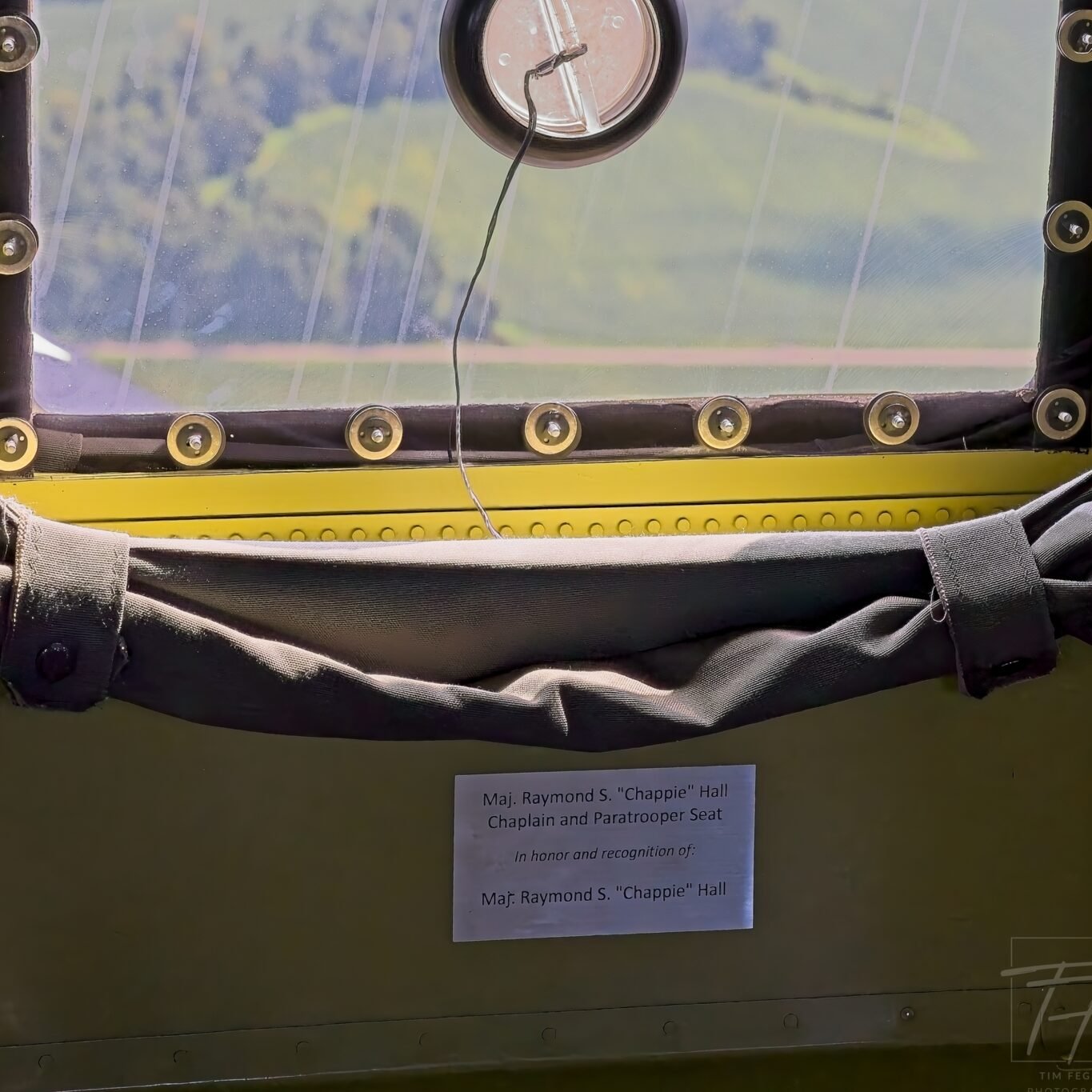 Empty paratrooper seat aboard the C-47 That’s All, Brother, with a plaque honoring Maj. Raymond S. “Chappie” Hall.