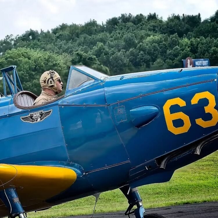 Fairchild PT-19 Miss Cornelia with her pilot seated in the open cockpit.