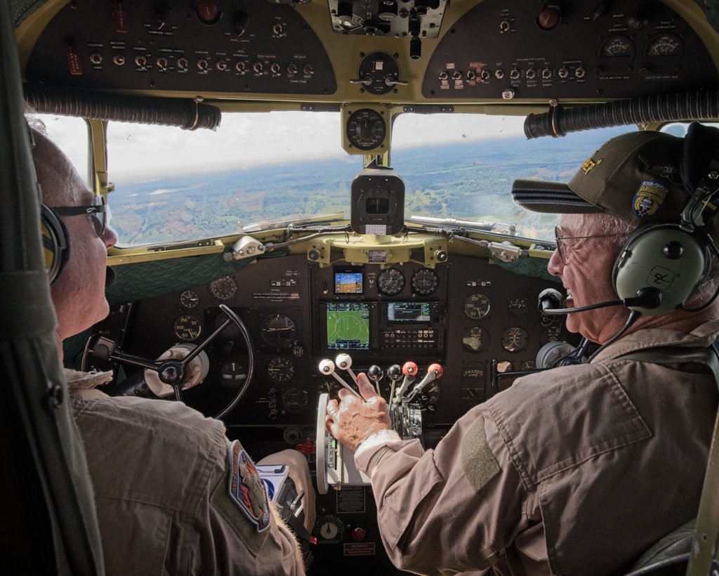 Daniel Wotring and Larry Lumpkin flying the C-47 That’s All, Brother, viewed from behind the cockpit seats.